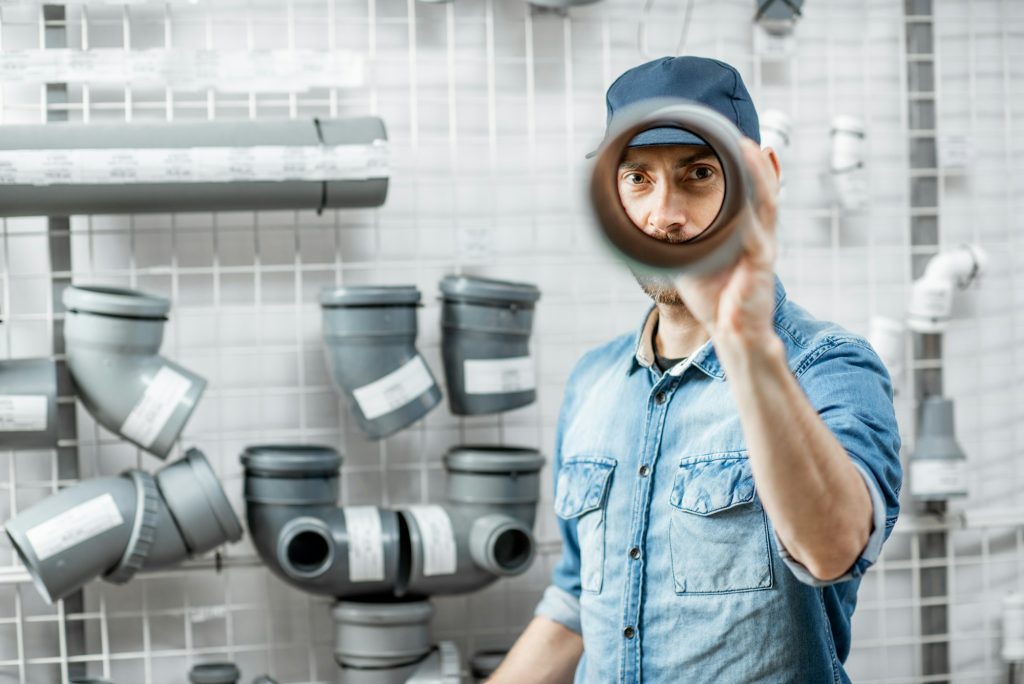 Man choosing pipes in the plumbing shop